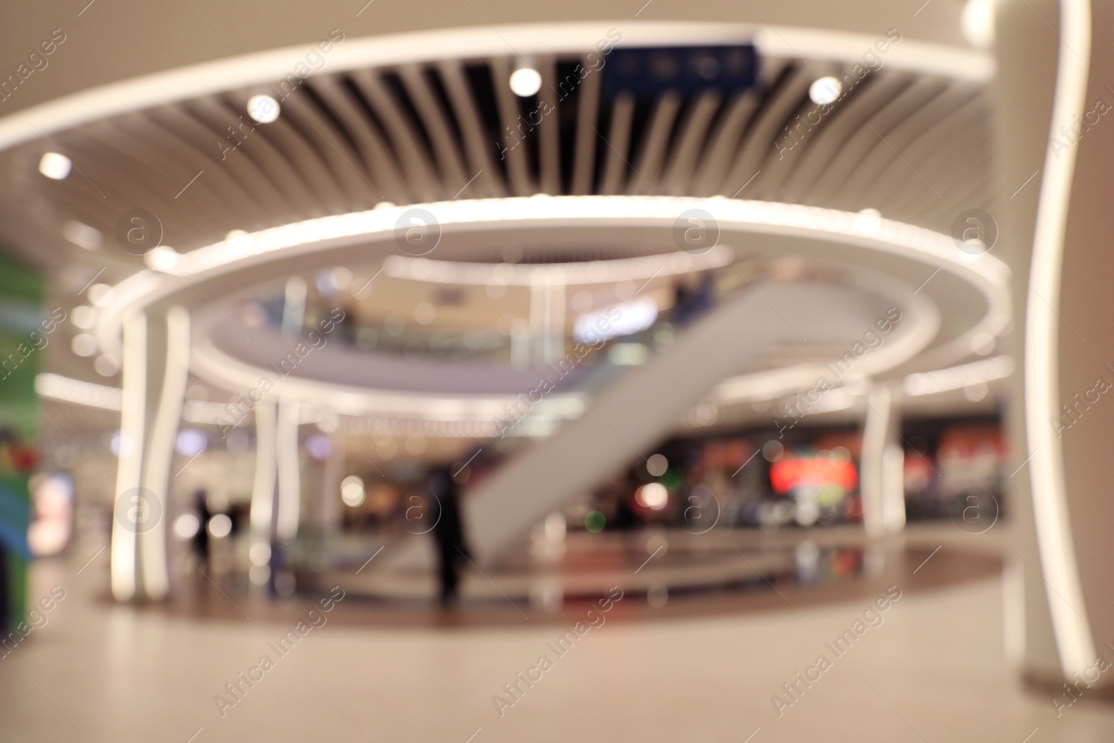 Photo of Blurred view of modern shopping mall interior. Bokeh effect