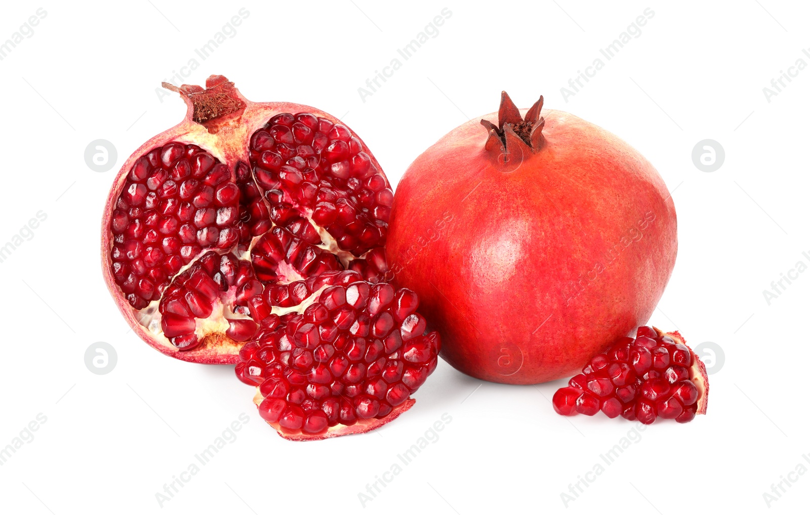 Photo of Half and whole pomegranates isolated on white