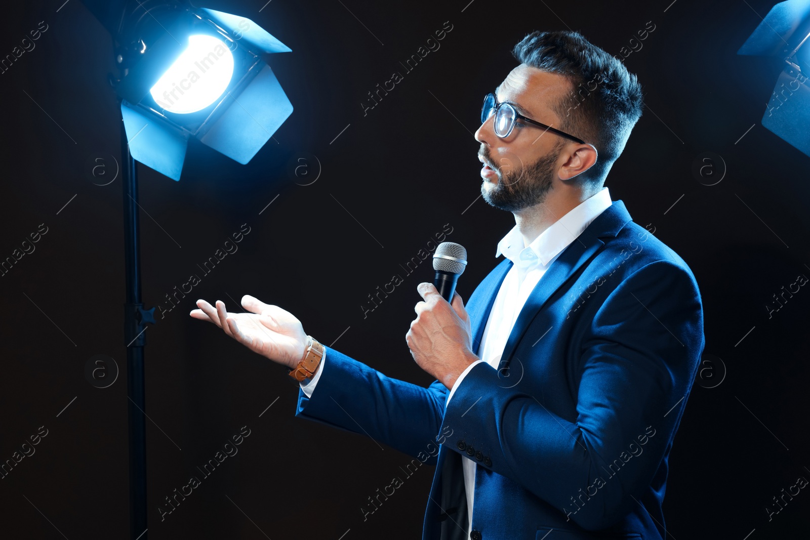 Photo of Motivational speaker with microphone performing on stage