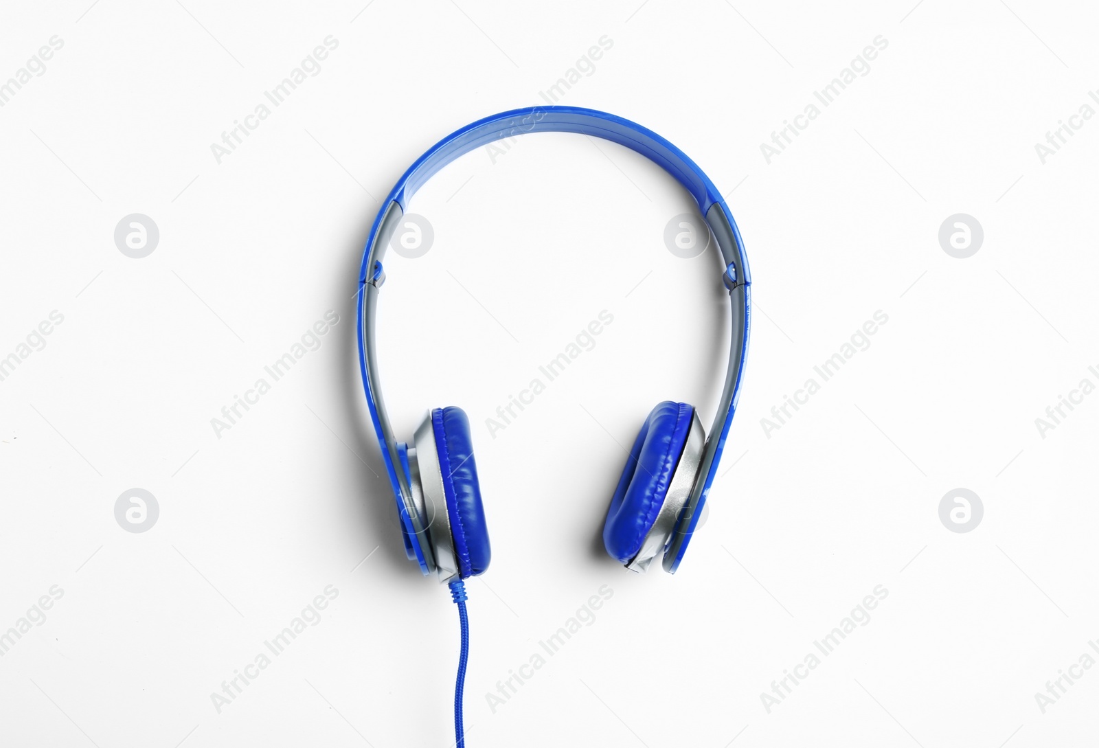 Photo of Stylish modern headphones on white background, top view