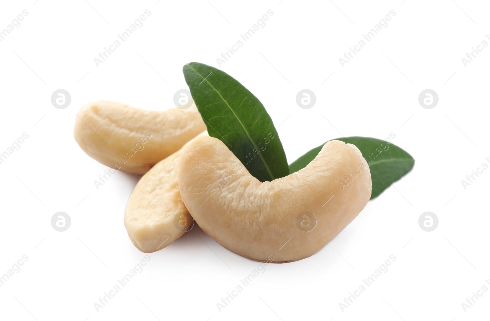 Photo of Tasty organic cashew nuts and green leaves isolated on white, closeup