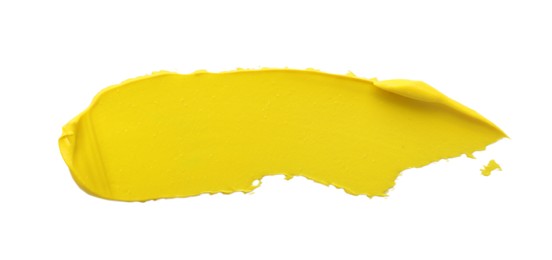 Photo of Yellow oil paint stroke on white background, top view