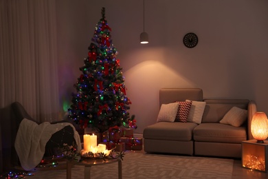 Photo of Stylish room interior with decorated Christmas tree