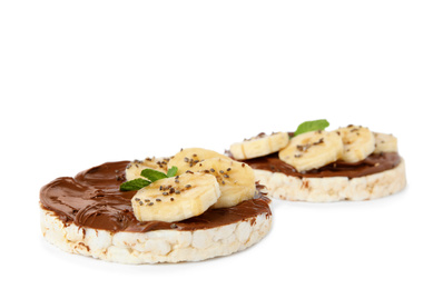 Photo of Puffed rice cakes with chocolate spread, banana and mint isolated on white