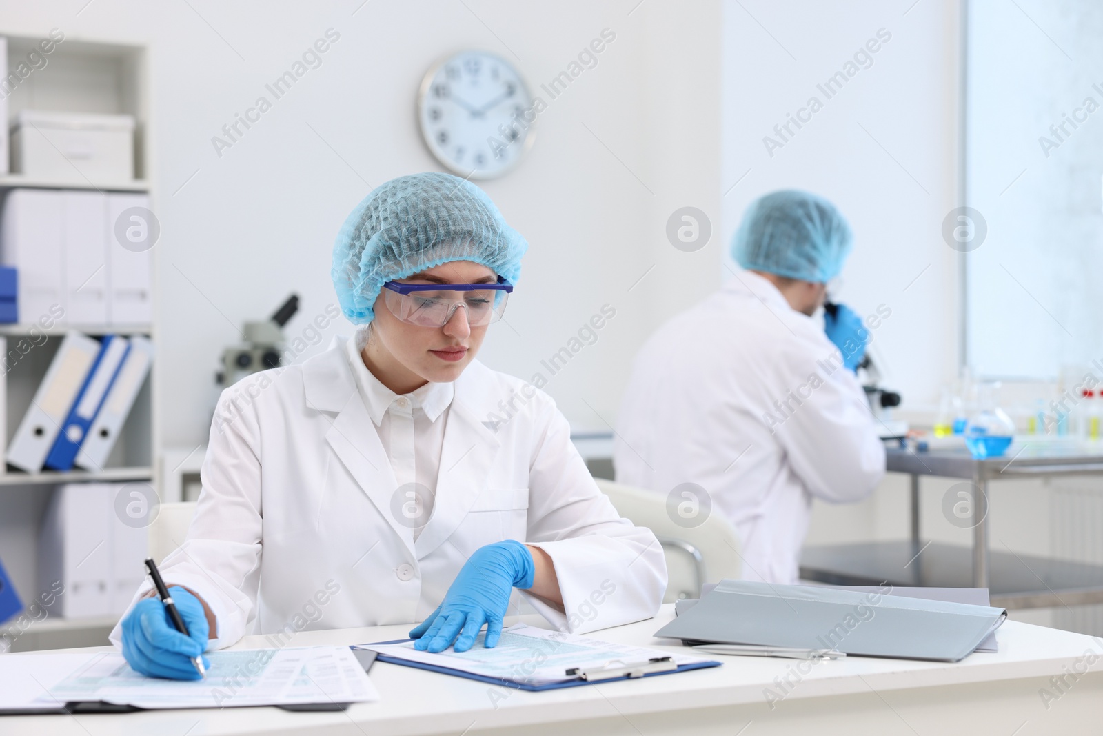 Photo of Quality control. Food inspectors checking safety of products in laboratory