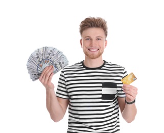 Happy young man with money and credit card on white background