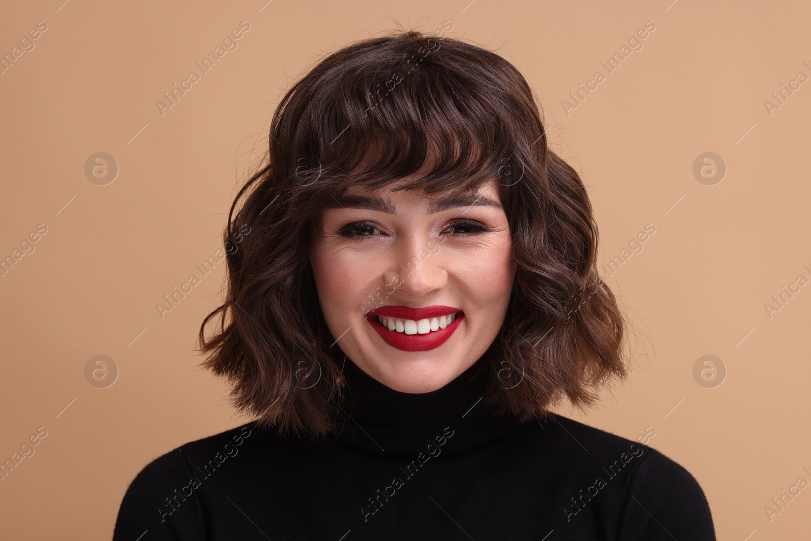 Photo of Portrait of beautiful young woman with wavy hairstyle on beige background