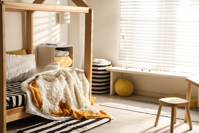 Cozy child room interior with comfortable bed