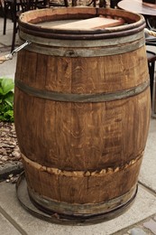 Photo of Traditional wooden barrel on city street outdoors