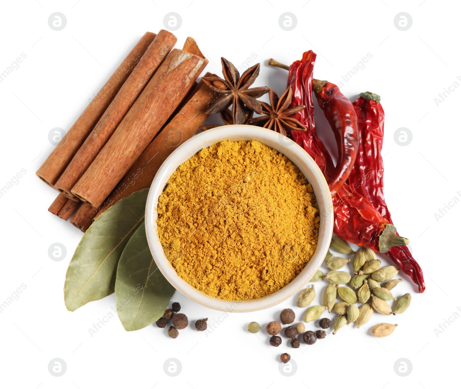 Photo of Curry powder in bowl and other spices isolated on white, top view