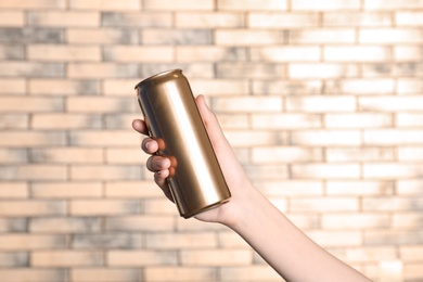 Photo of Woman holding aluminum can on blurred background