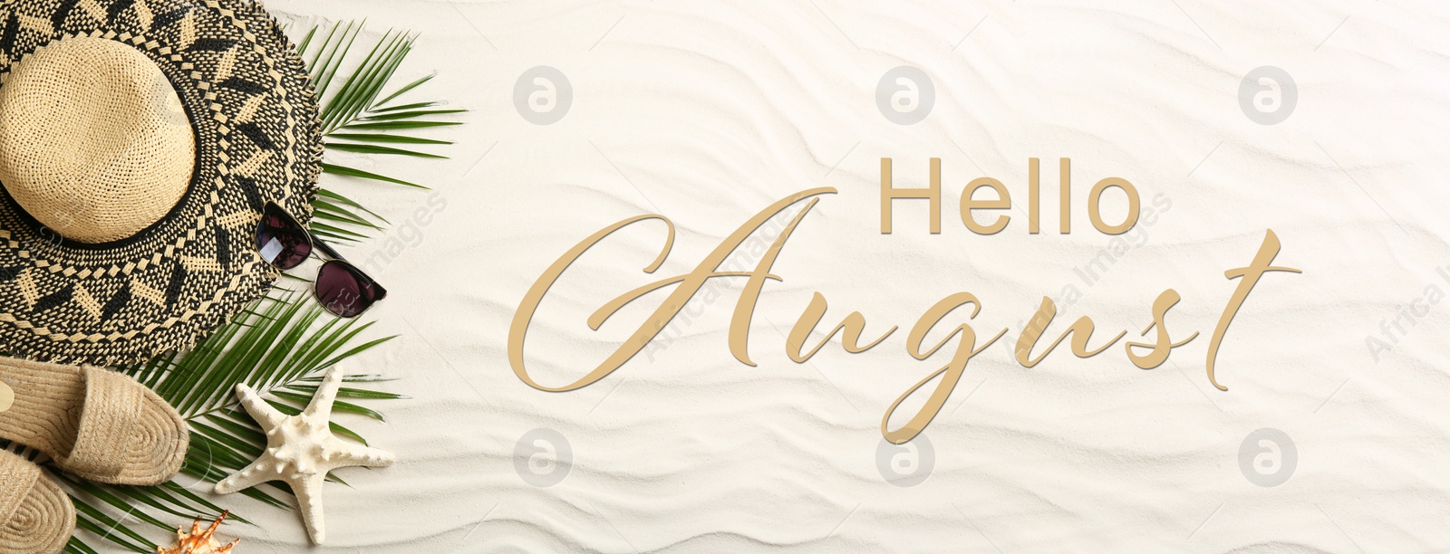 Image of Hello August. Different beach accessories on sand, flat lay