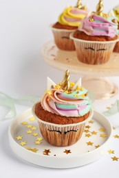 Photo of Cute sweet unicorn cupcakes on white table