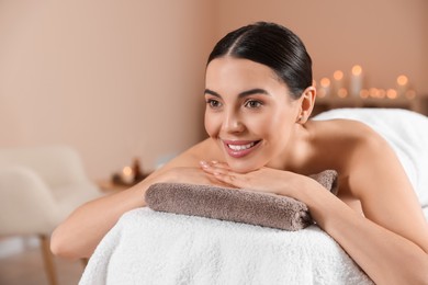 Young woman resting on massage couch in spa salon