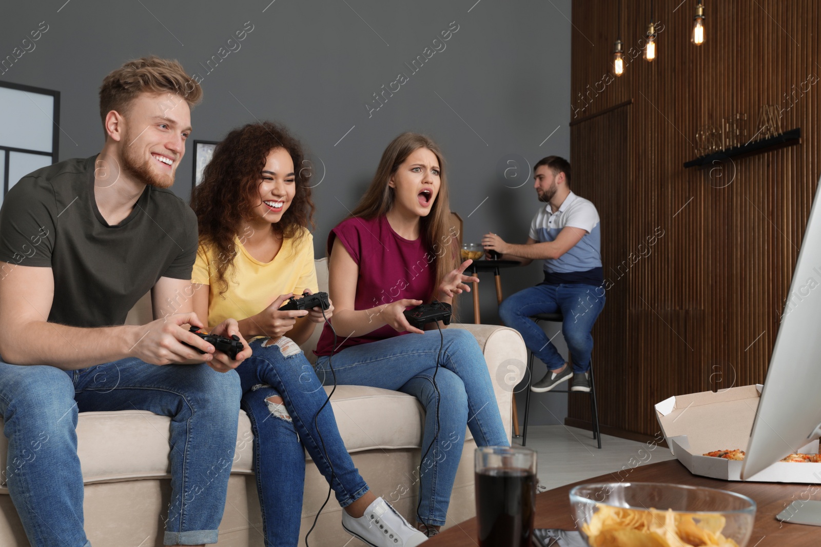 Photo of Emotional friends playing video games at home