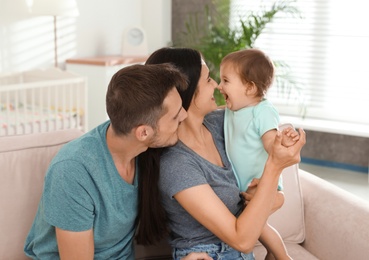 Happy family with adorable little baby at home