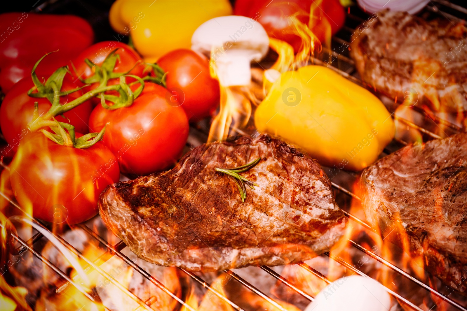 Image of Barbecue grill with food and flame, closeup