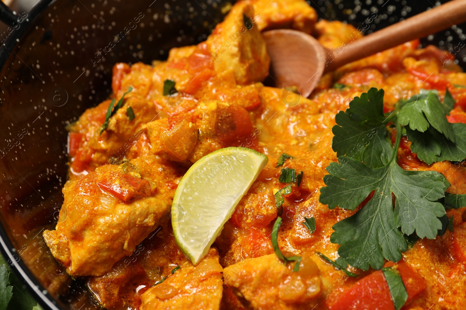 Photo of Delicious chicken curry in frying pan, closeup