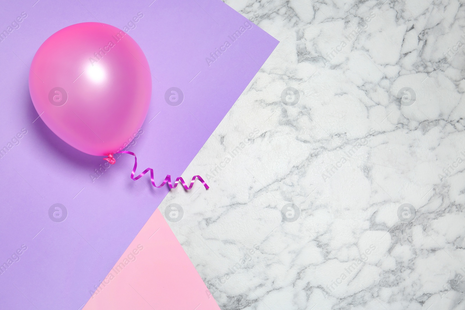 Photo of Bright balloon on colorful background, top view with space for text. Party time