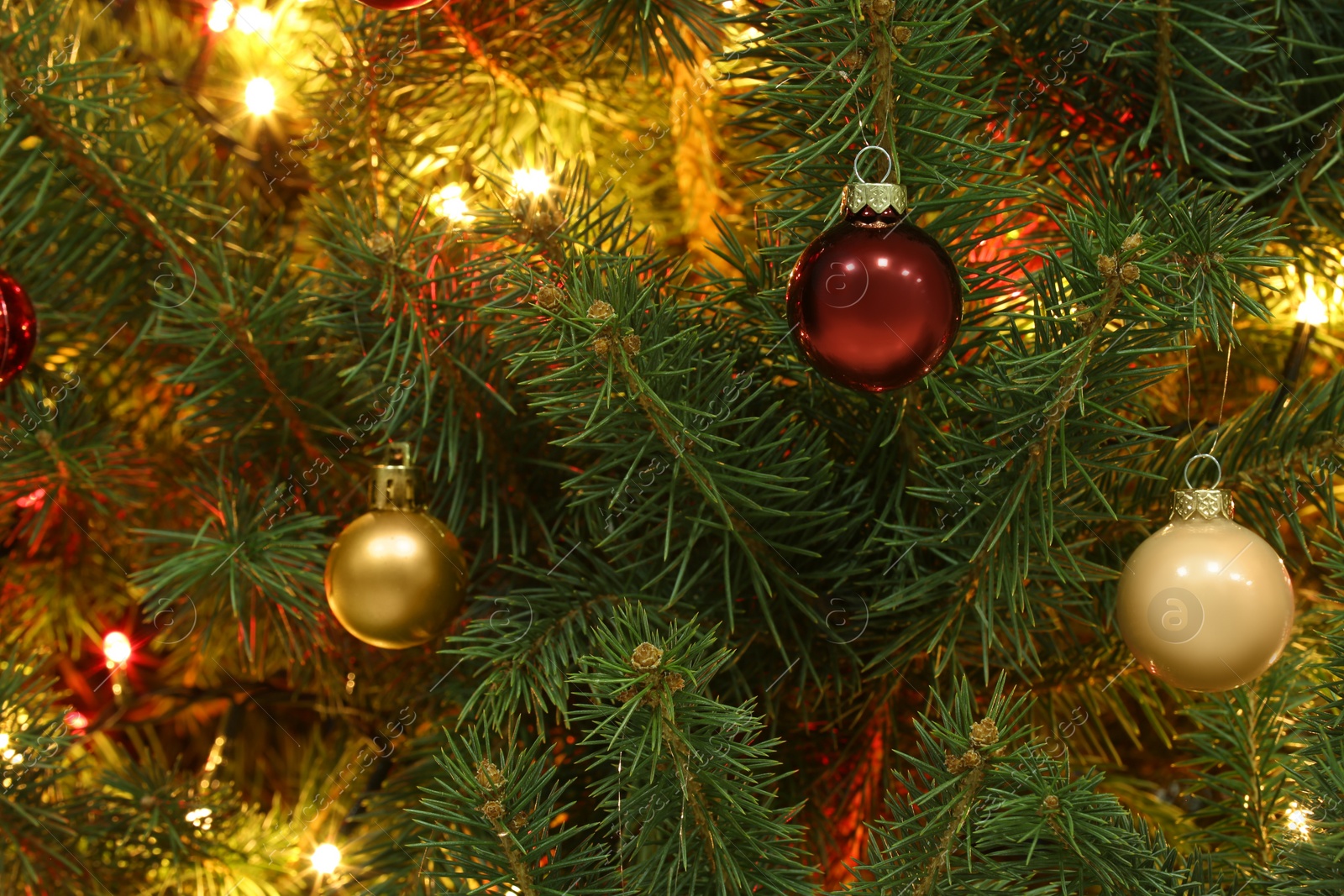 Photo of Glowing bright fairy lights and beautiful baubles on Christmas tree