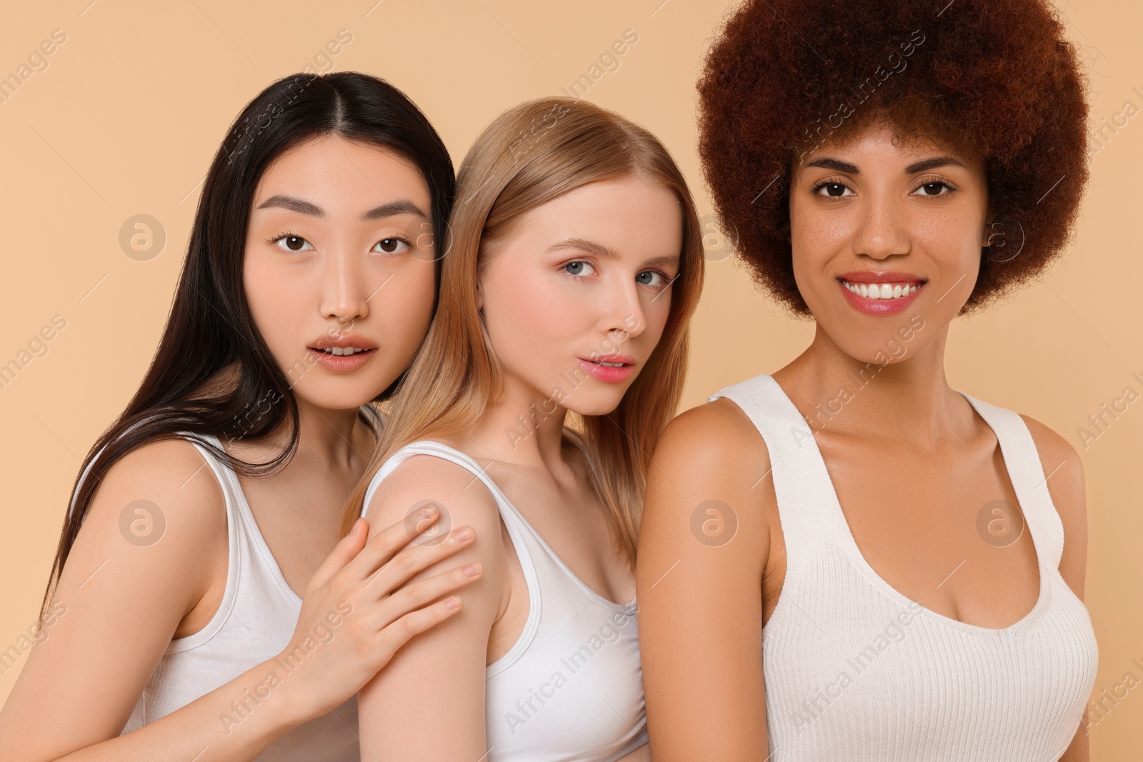 Photo of Portrait of beautiful young women on beige background