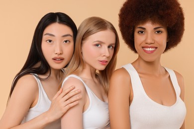 Photo of Portrait of beautiful young women on beige background