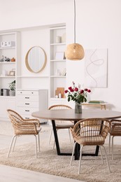Stylish dining room interior with table and chairs
