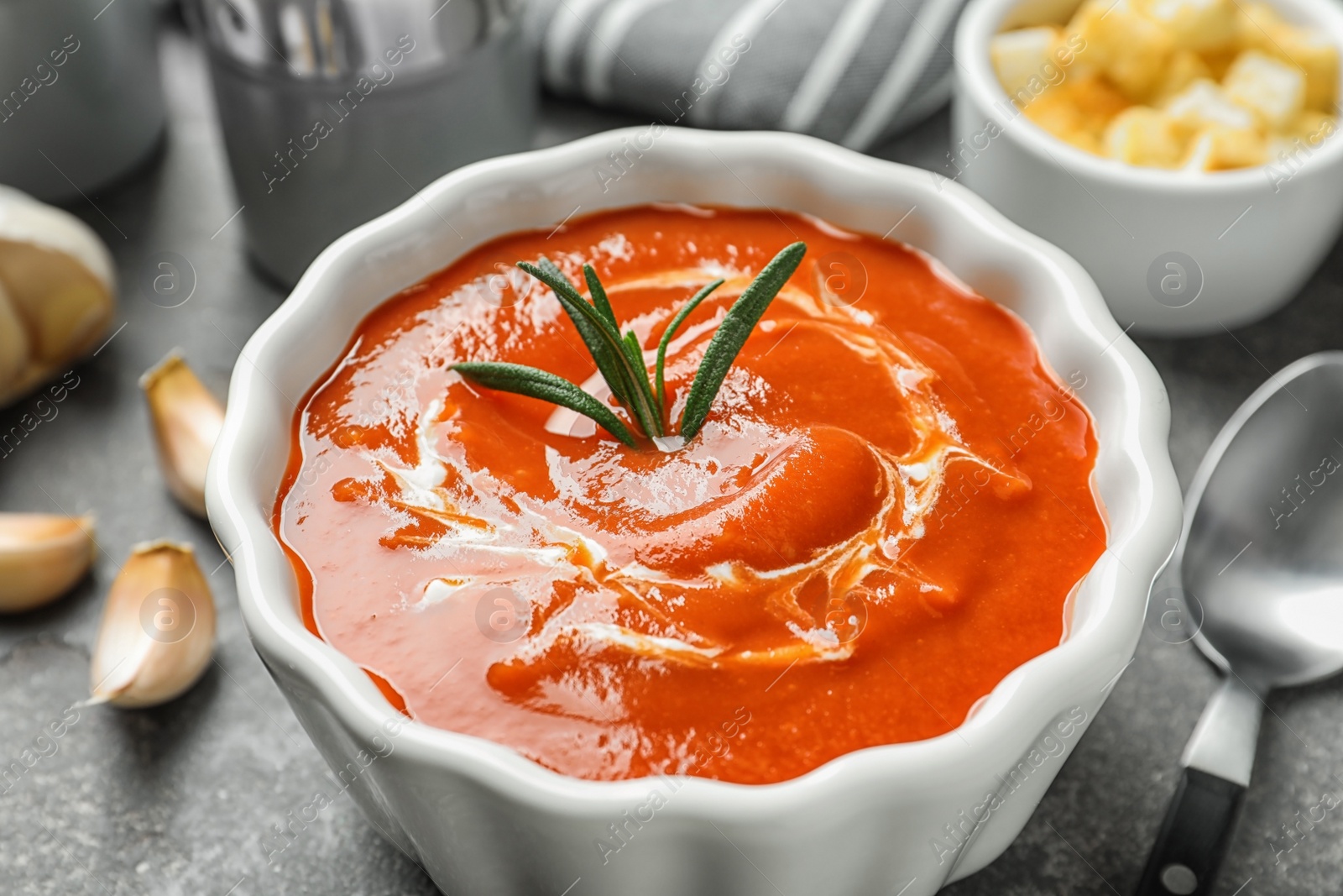 Photo of Bowl with delicious fresh homemade tomato soup on table