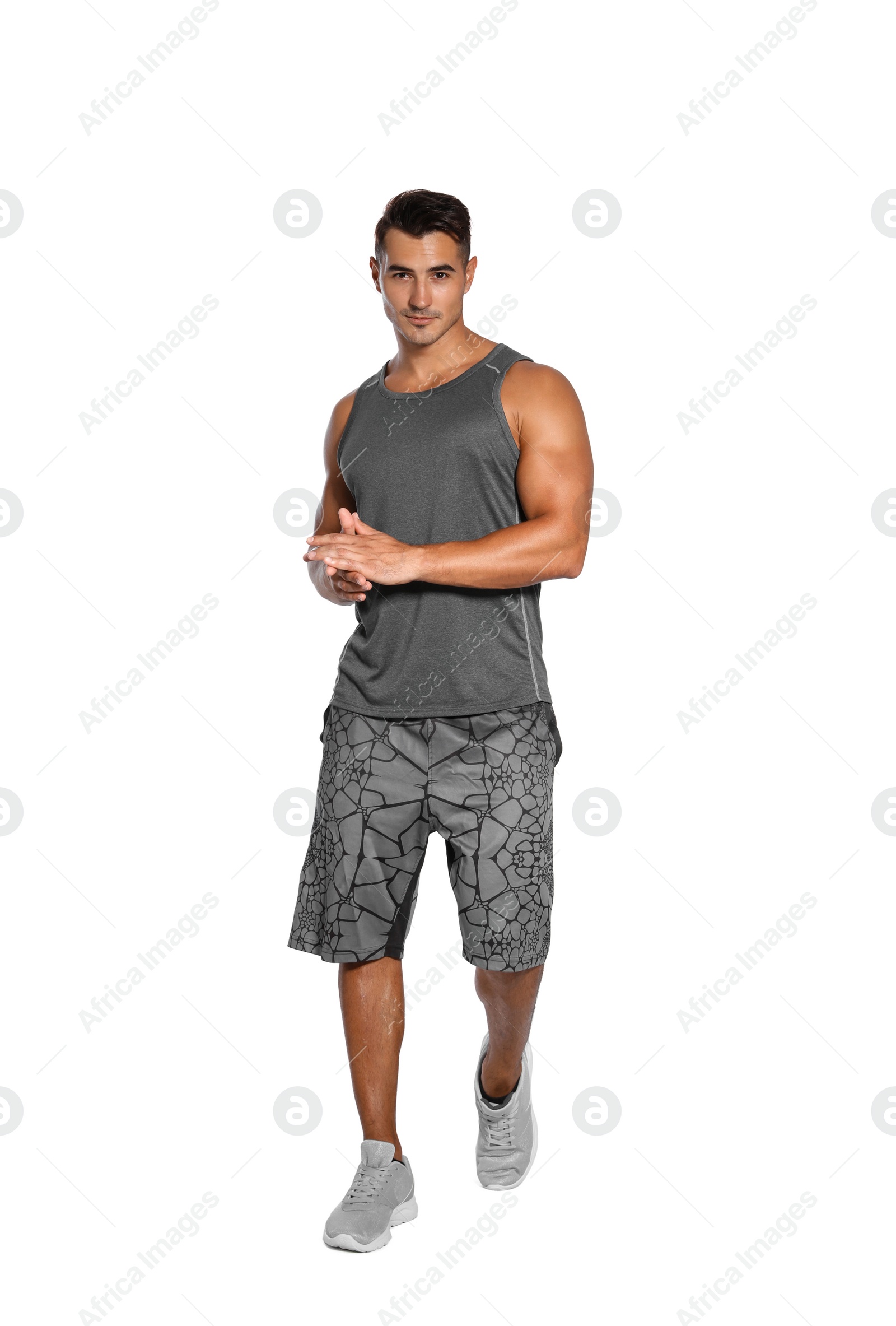 Photo of Handsome young runner posing on white background