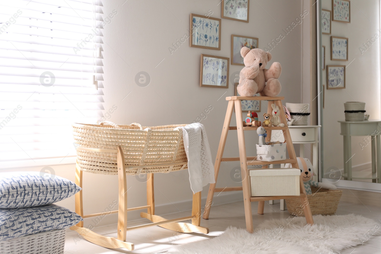 Photo of Decorative ladder with toys and different stuff in stylish baby room. Idea for interior design