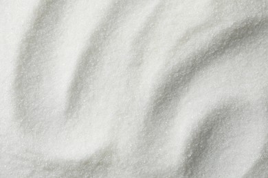 Photo of White granulated sugar as background, top view