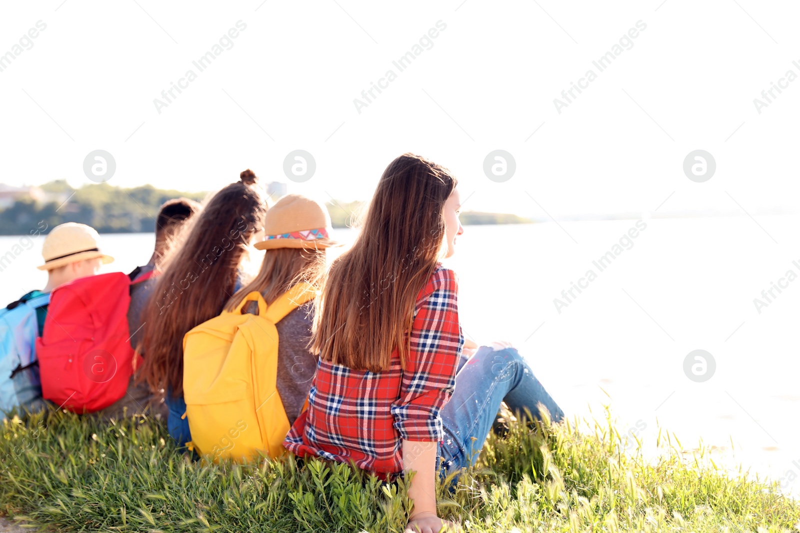 Photo of Group of children with backpacks on coast. Summer camp