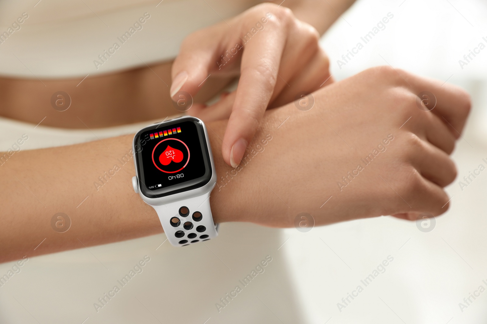 Image of Young woman using smart watch during training, closeup
