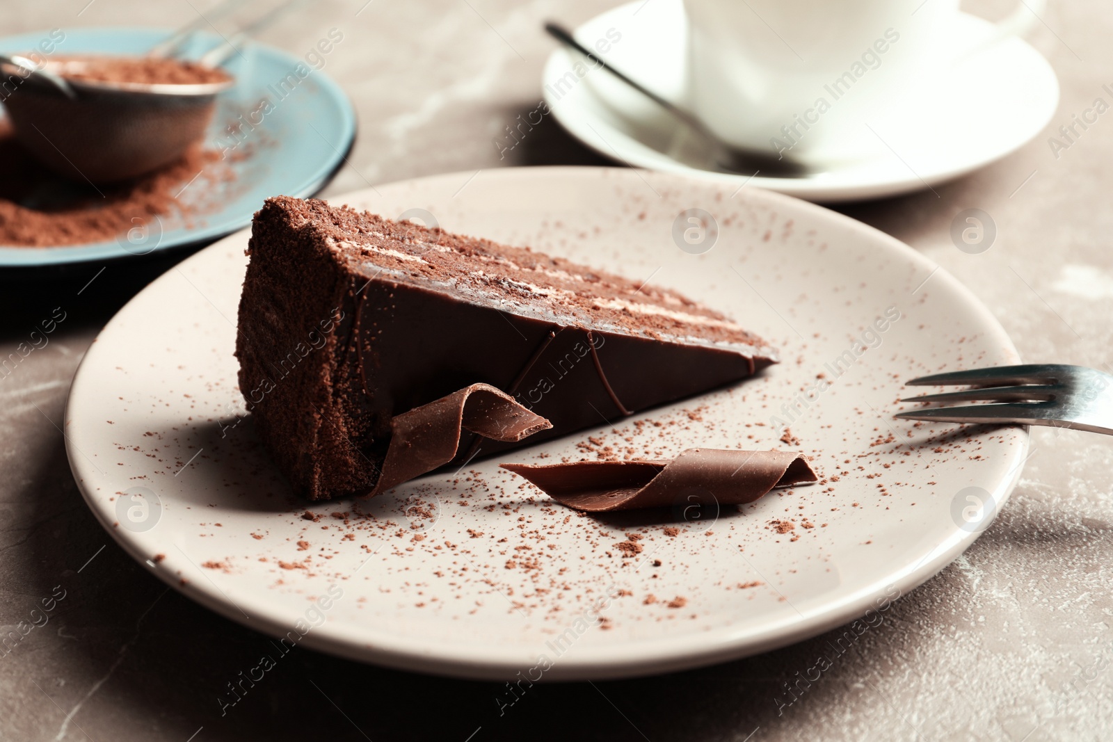 Photo of Plate with slice of tasty homemade chocolate cake on table