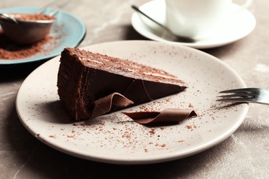 Photo of Plate with slice of tasty homemade chocolate cake on table