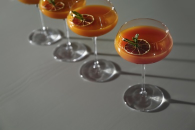 Photo of Glasses of delicious cocktail with vodka on table in bar