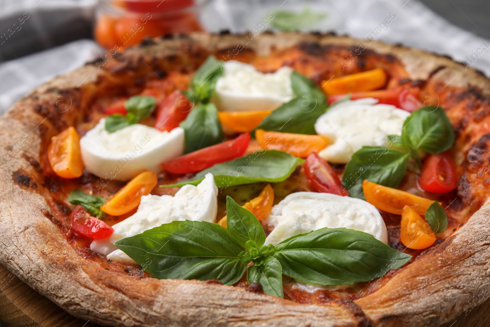 Photo of Delicious pizza with burrata cheese, tomatoes and basil on table, closeup