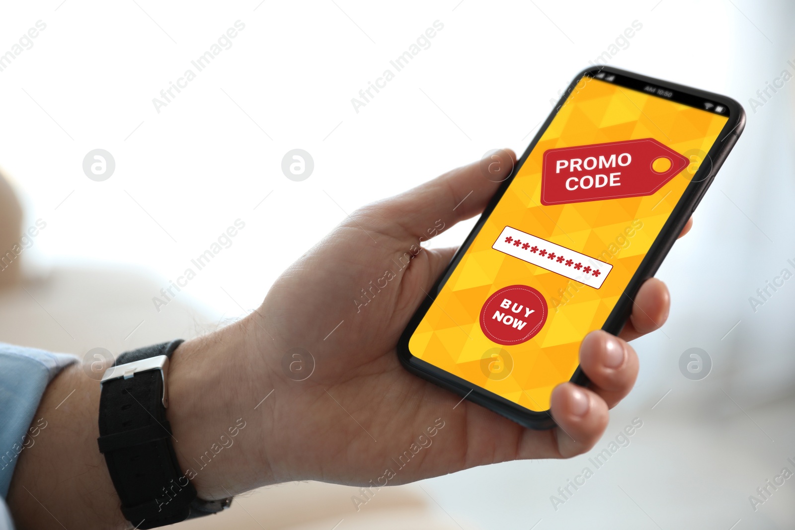 Image of Man holding smartphone with activated promo code in online shopping app indoors, closeup