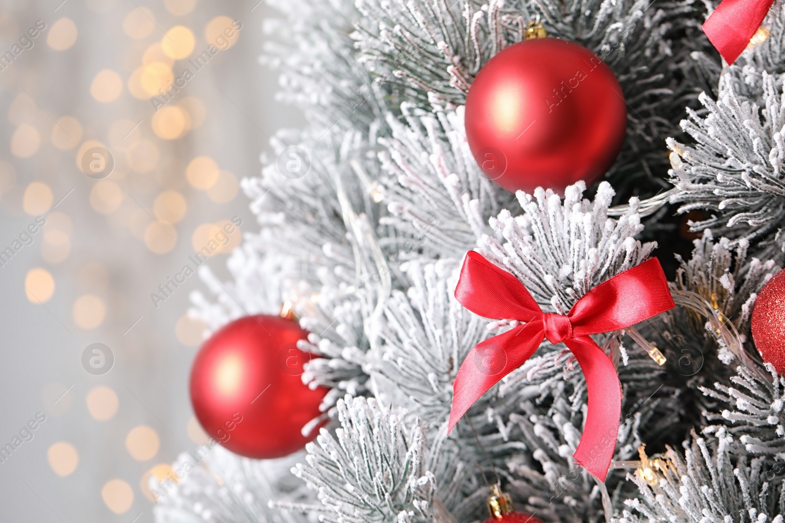 Photo of Beautiful Christmas tree with decor against blurred lights on background