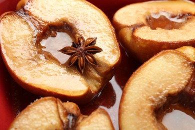 Photo of Tasty baked quinces with anise and honey in dish, closeup