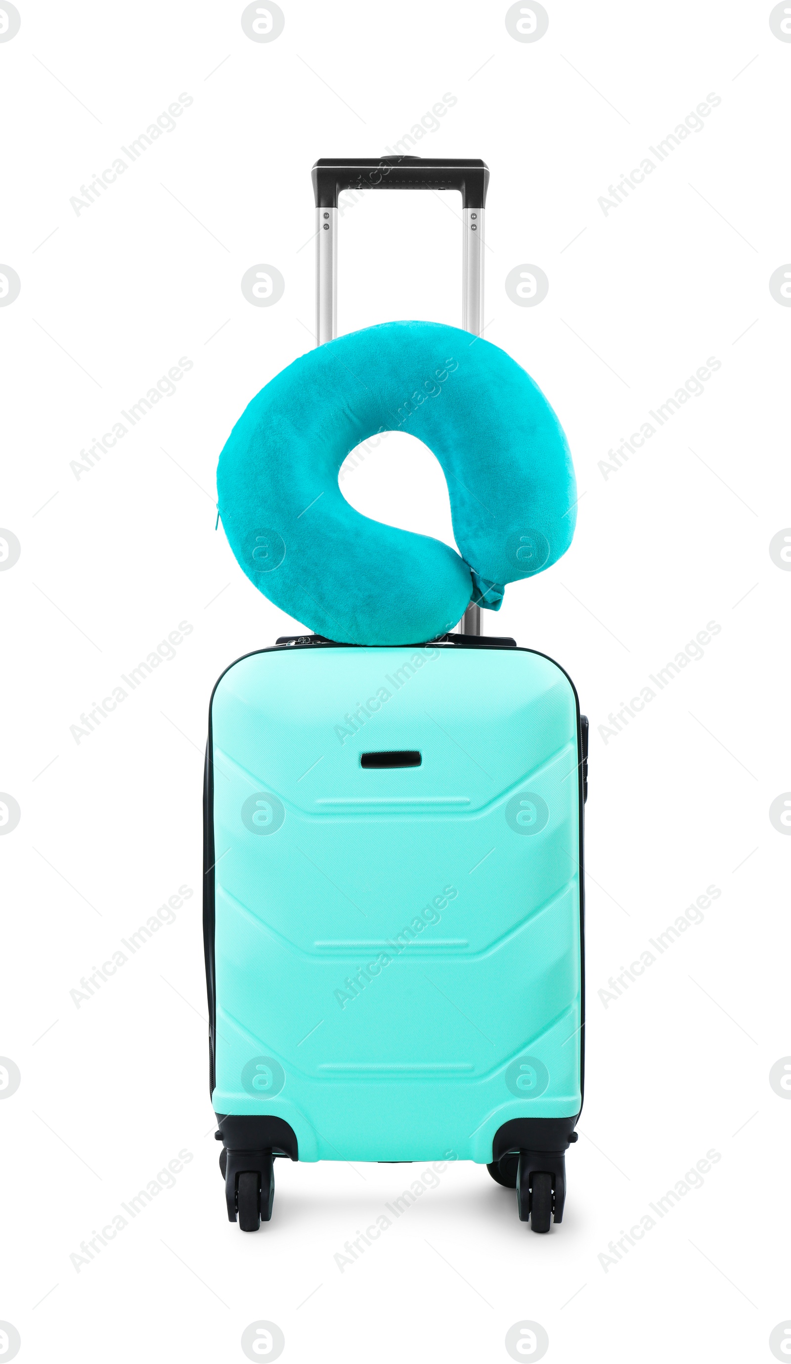 Photo of Soft travel pillow on turquoise suitcase isolated on white