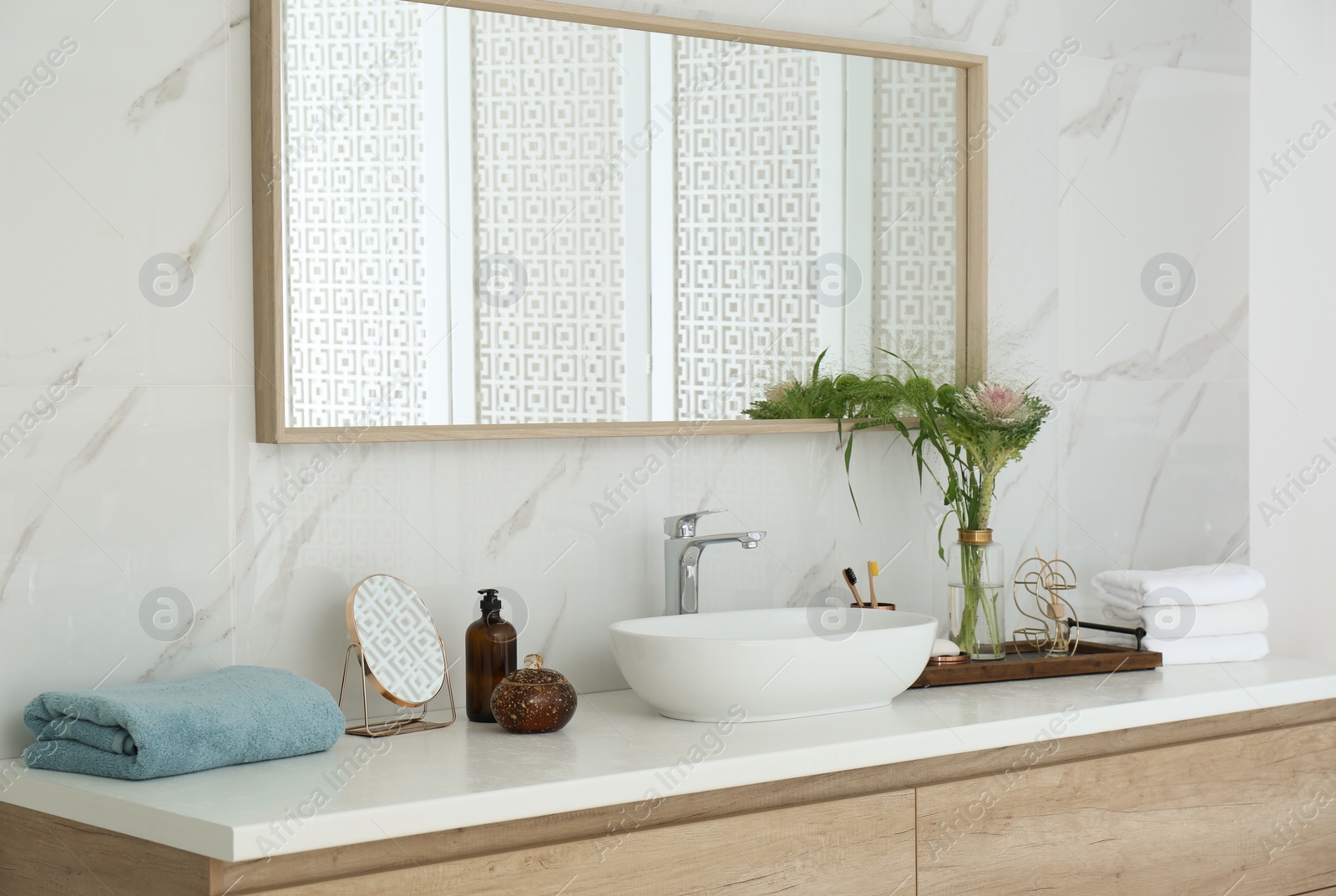 Photo of Modern bathroom interior with stylish mirror and vessel sink