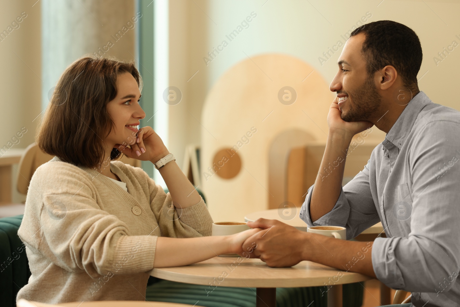 Photo of Romantic date. Happy couple spending time together in cafe