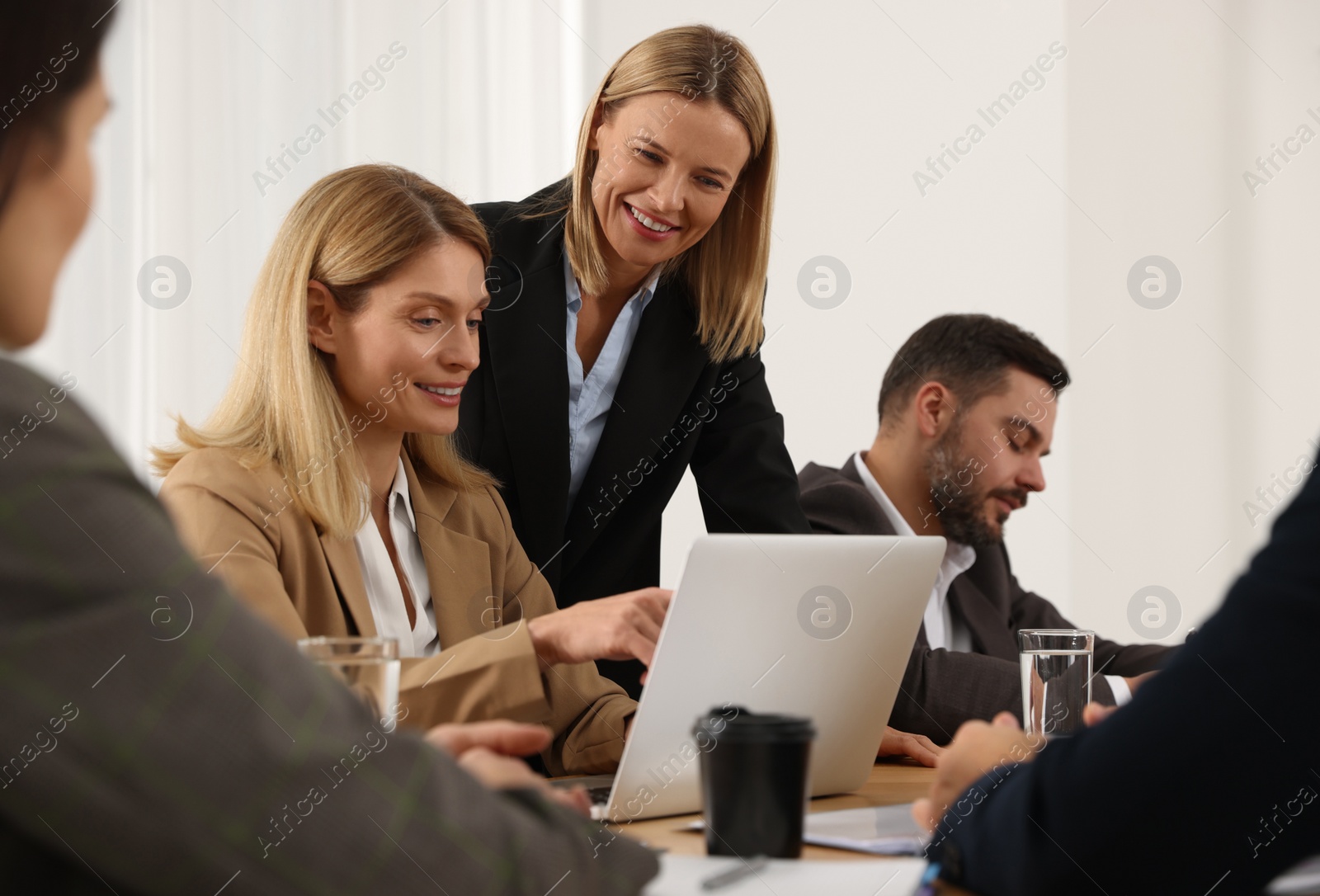 Photo of Businesswoman having meeting with her employees in office