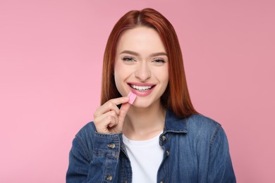 Photo of Beautiful woman with bubble gum on pink background