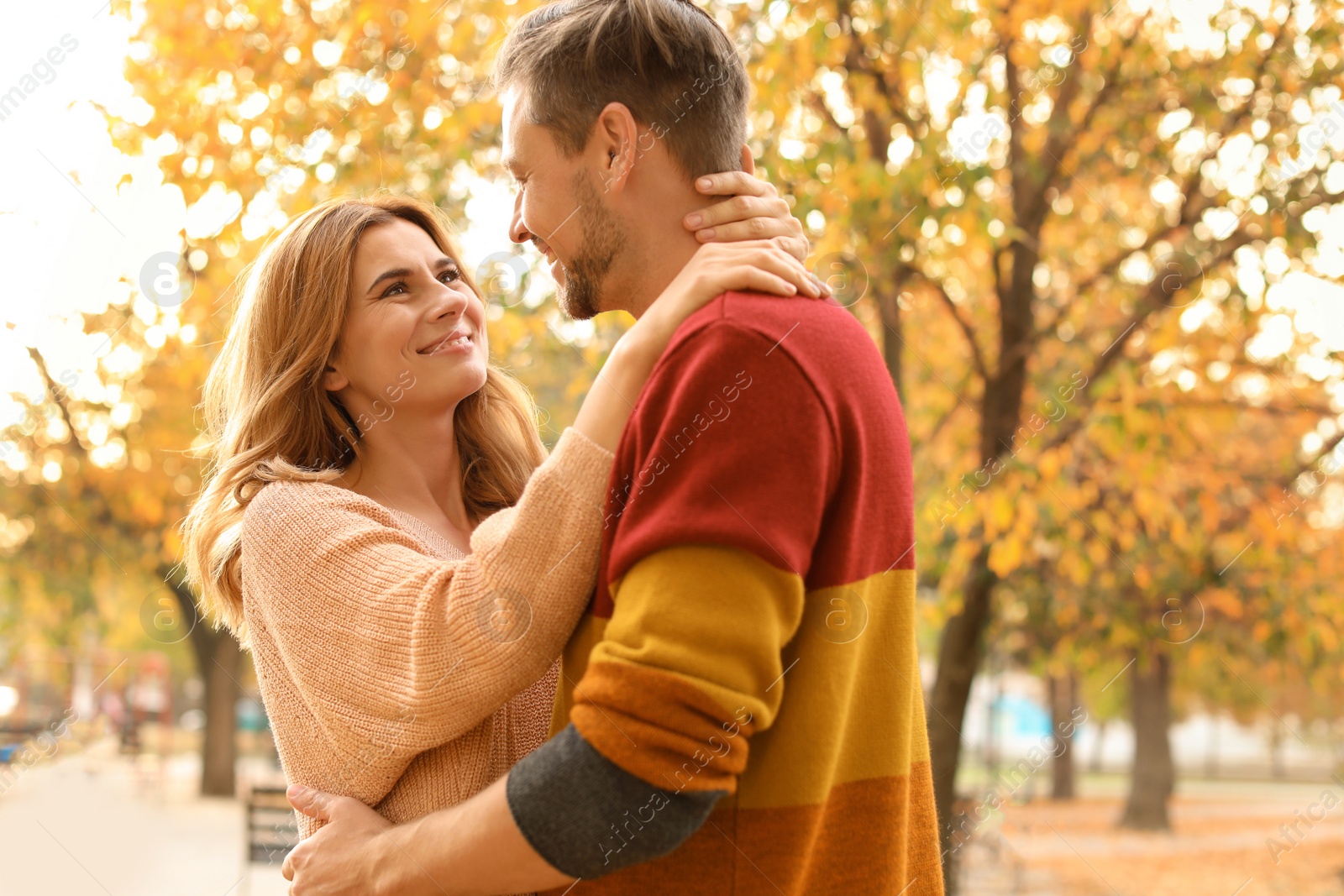 Photo of Lovely couple spending time together in park. Autumn walk