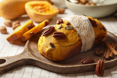 Delicious pumpkin bread with pecan nuts on tablecloth