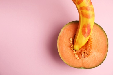 Photo of Flat lay composition with fresh banana and melon on pink background, space for text. Sex concept