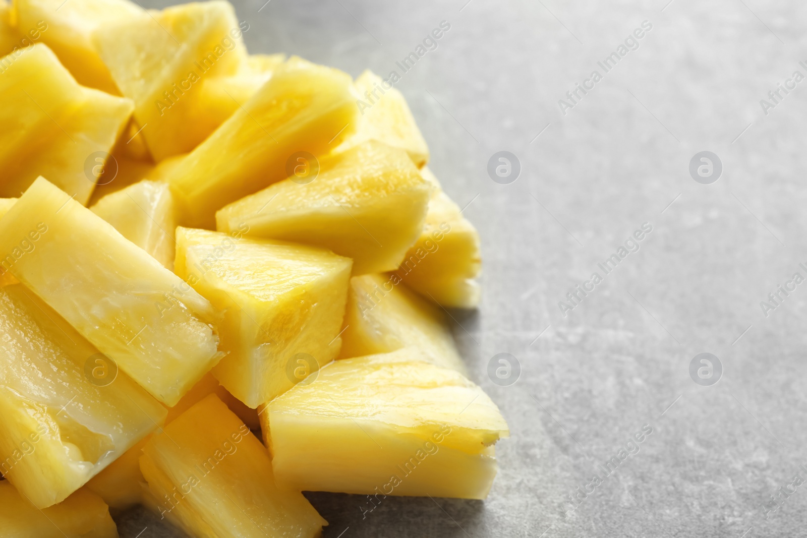 Photo of Slices of fresh pineapple on grey background