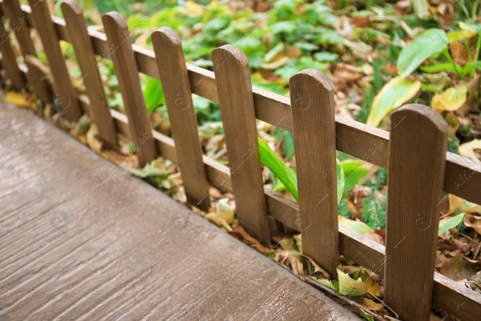 Photo of Closeup view of small wooden fence outdoors